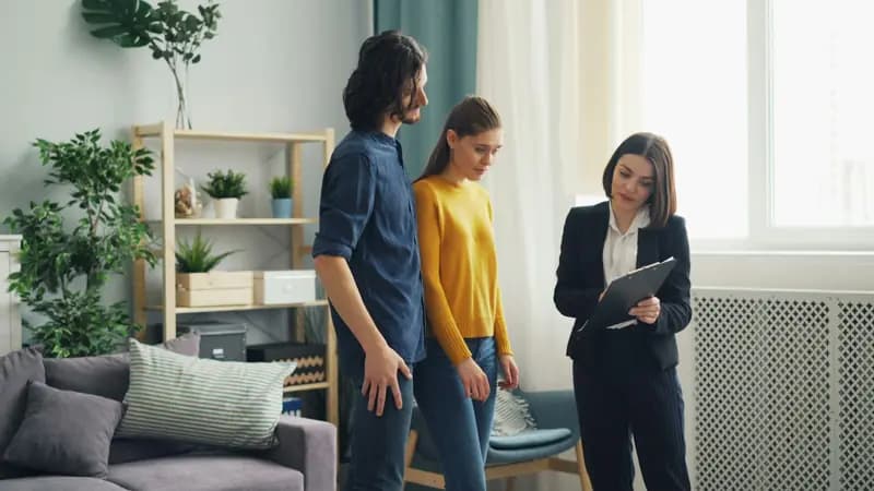 Letting agent showing a couple round a flat
